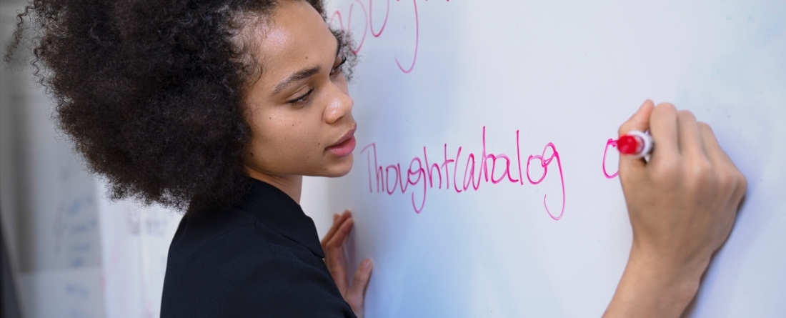 Woman writing on whiteboard